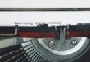 black and red typewriter on white table