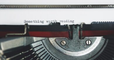 black and red typewriter on white table