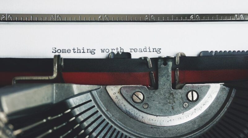 black and red typewriter on white table