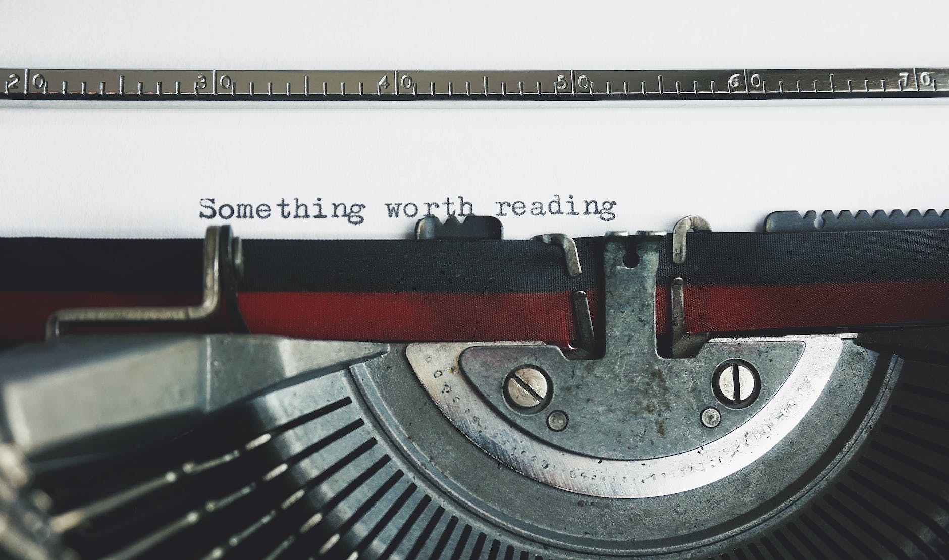 black and red typewriter on white table